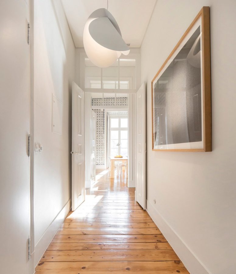 The apartment got a modern renovation with chic light fixtures and works of art
