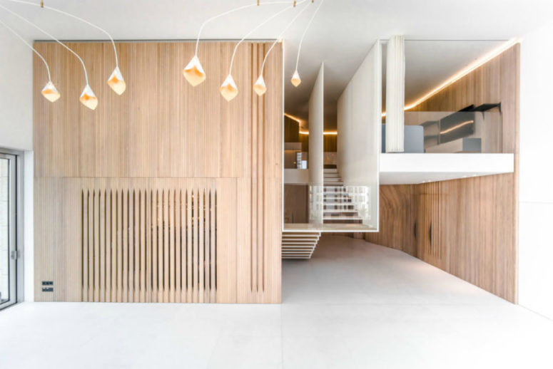 Wooden walls look surprisingly cool and contemporary, and they are highlighted with cool ceiling lamps with a surreal design