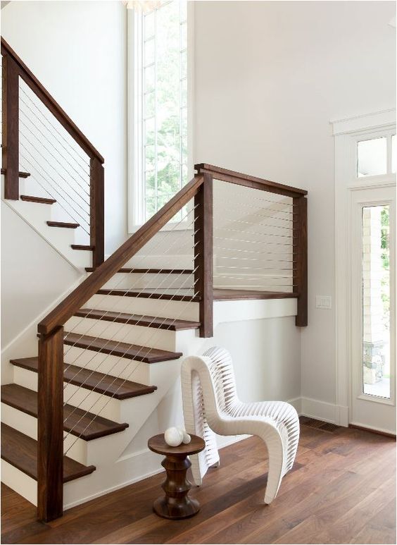 dark wood and cable railing with white steps look chic and modern