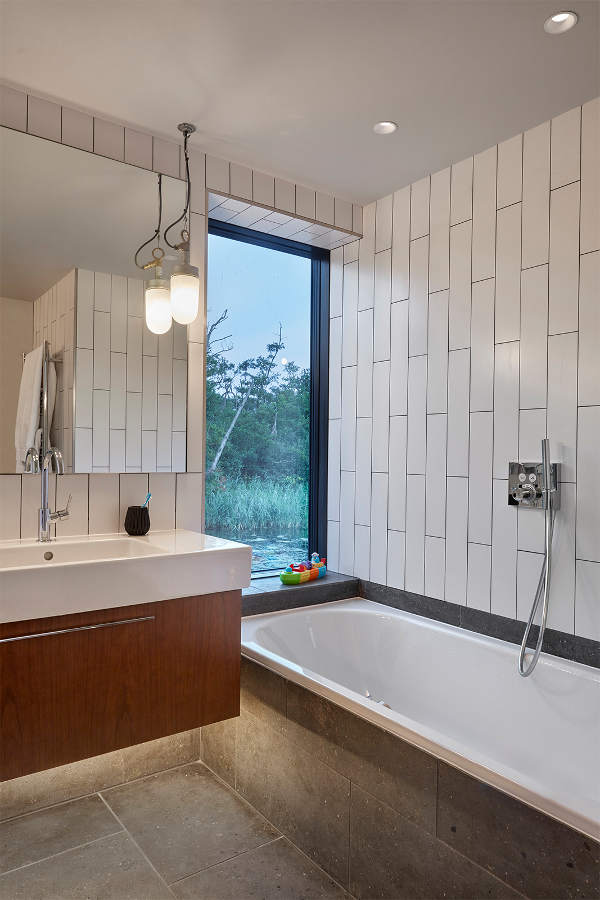 The master bathroom has views also, a floating vanity and concrete panels for durability