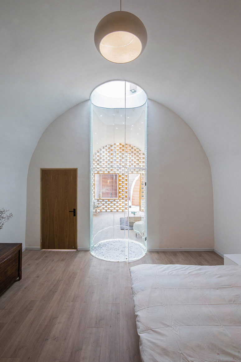 The central skylight creates a light tunnel separating the bedroom and living space