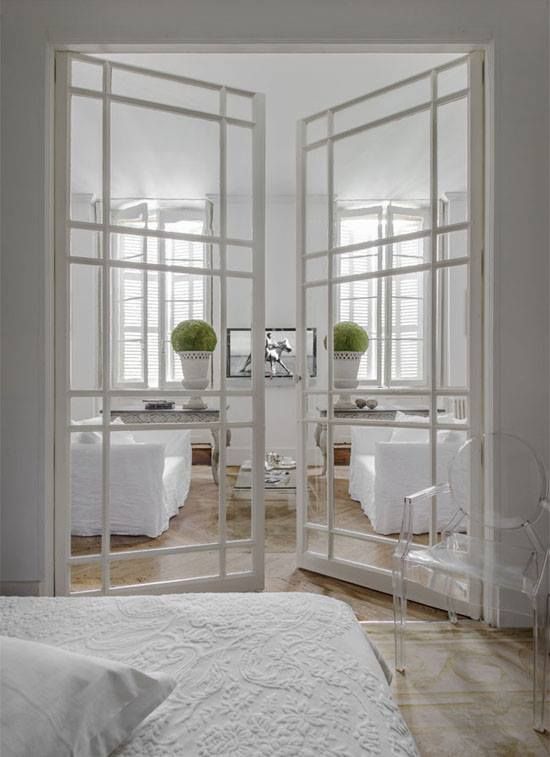 exquisite take on traditional French doors, wood painted white with adorable framing
