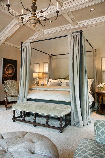 luxurious bedroom with a dark bed and neutral green fabrics