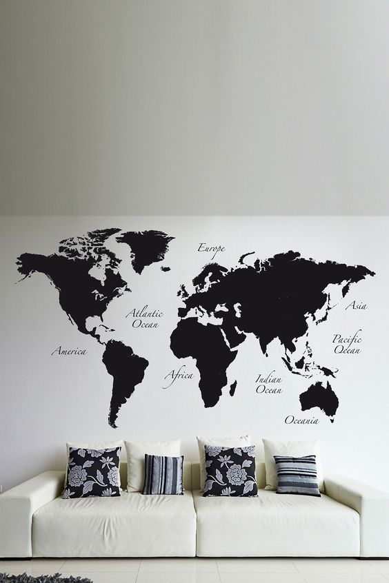 Minimalist black and white living room with black world map wall decals.