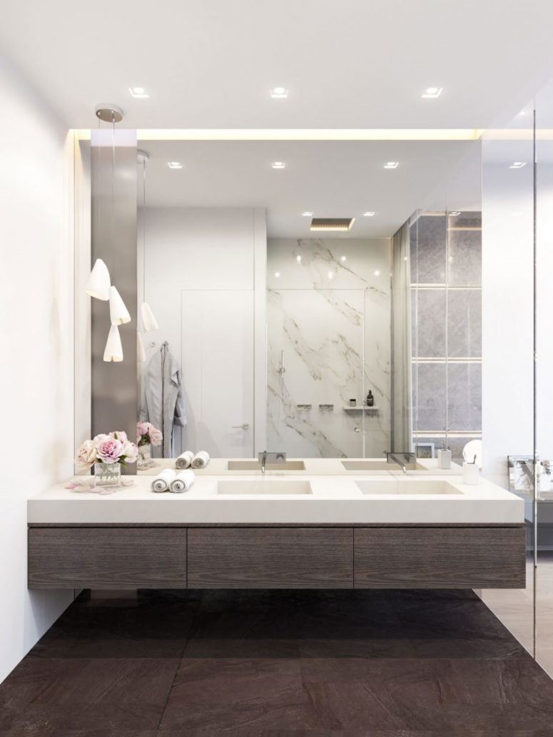 modern bathroom with dark woods, white marble and a mirror wall