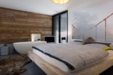 12 The bedroom has a boho feel with a free-standing bathtub by the bed