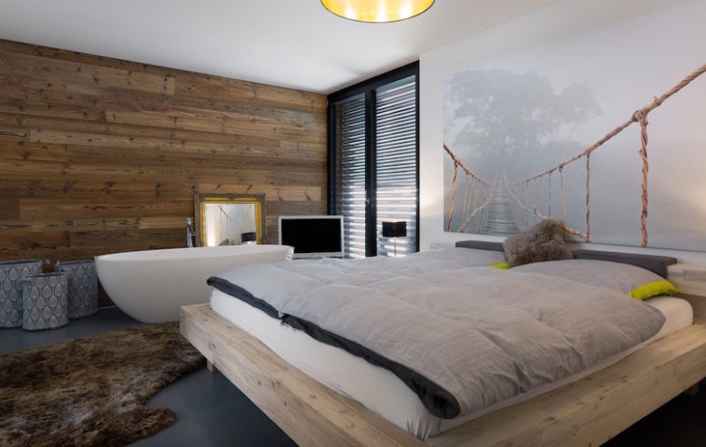 The bedroom has a boho feel with a free-standing bathtub by the bed