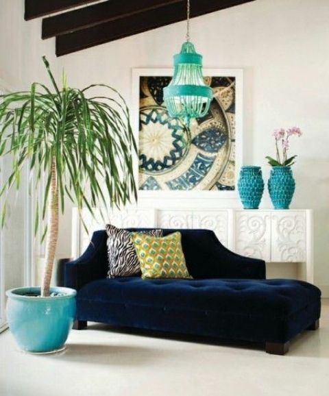 a navy sofa and turquoise accessories create an ambience in a neutral room