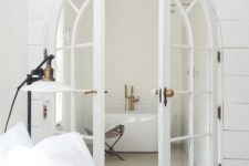 12 arched white French doors for airy and light-filled interiors