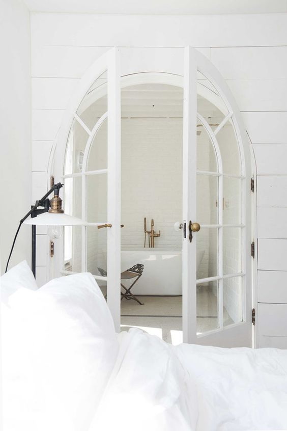 Arched white French doors for airy and light filled interiors