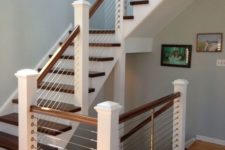 12 classic white and dark wood staircase is made more modern with cable railings