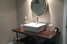 12 dark stained wooden and metal pipe vanity with baskets instead of drawers