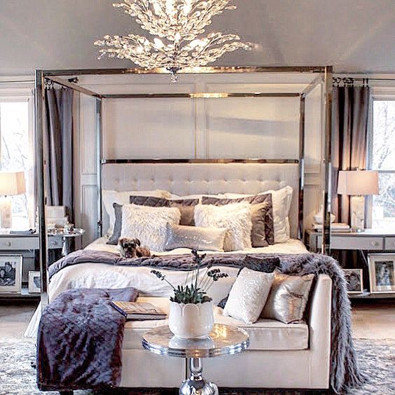 luxurious bedroom decor with a metal frame bed and a tufted headboard