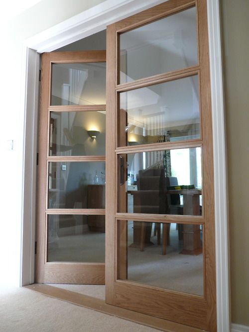 internal doors made from oak with glass paneling throughout; providing a simple yet elegant transition from living room to dining room