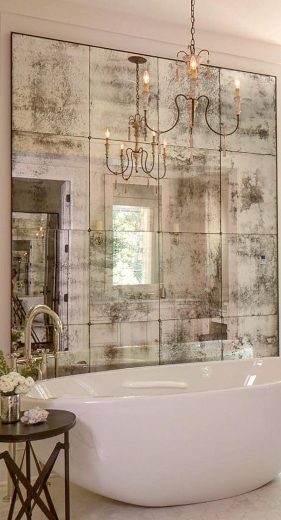 antique mirrors add a glamorous vintage vibe, and a chandelier highlights it
