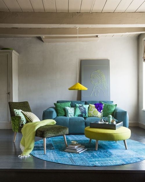 blue, emerald and lime green living room with a round carpet and a round coffee table