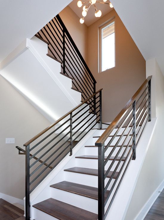 wooden banister and a wrought iron balustrade in modern style look chic and eye-catching
