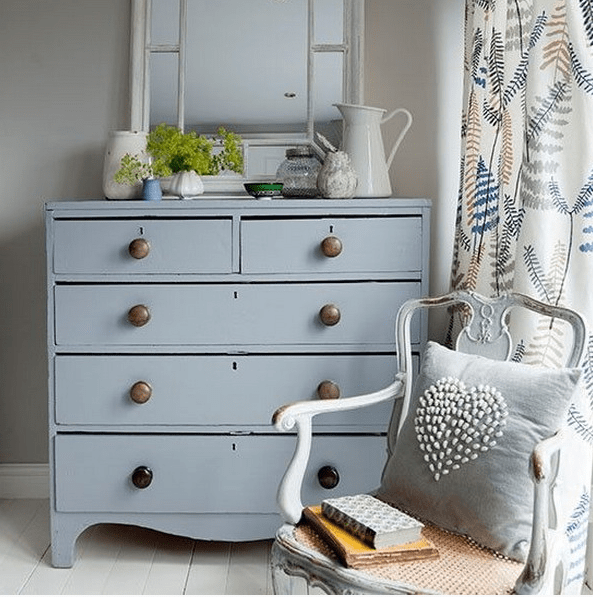 Grey dresser with metal knobs for a vintage style bedroom