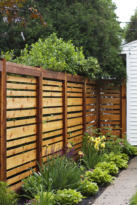 simple stained horizontal wooden fence will match any backyard decor