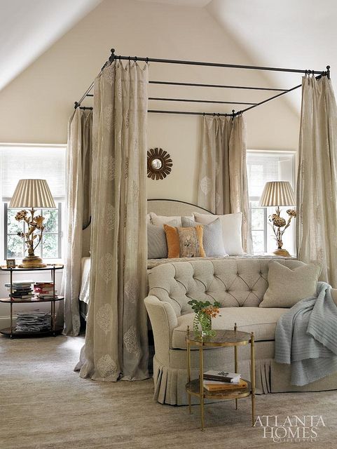 traditional bedroom with a canopy bed, the curtains fit the color scheme perfectly
