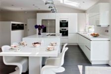 15 ultra-modern white kitchen and a corresponding dining space with sculptrual chairs