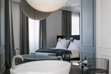 16 modern mirror wall, a free-standing bathtub and an oversized sphere lamp