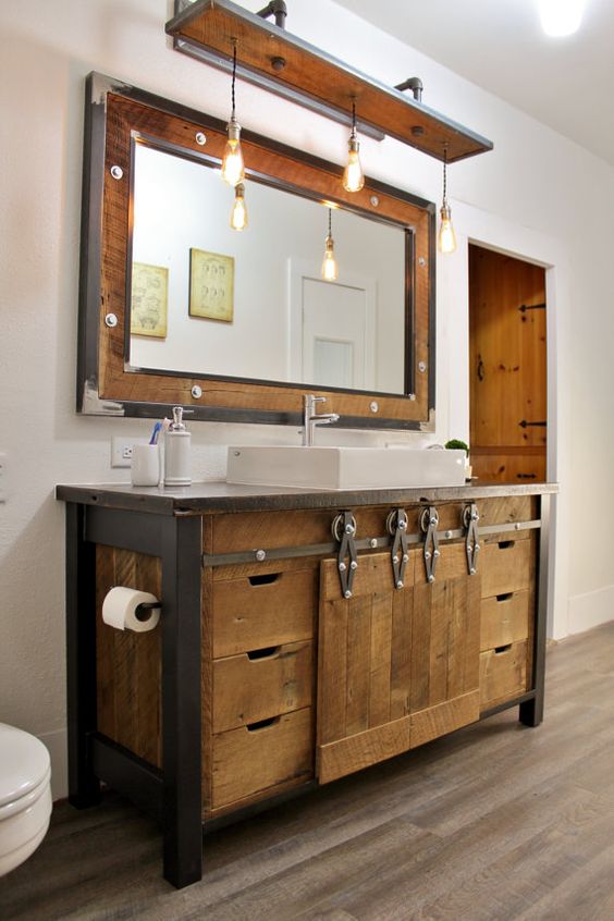 reclaimed wood bathroom vanity with metal details and the same mirror