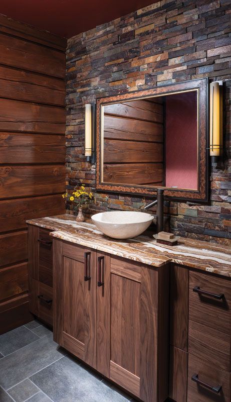 wooden vanity in warm hues with a stone countertop