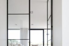 18 floor to ceiling black framed glass doors look perfect in a neutral modern ambience
