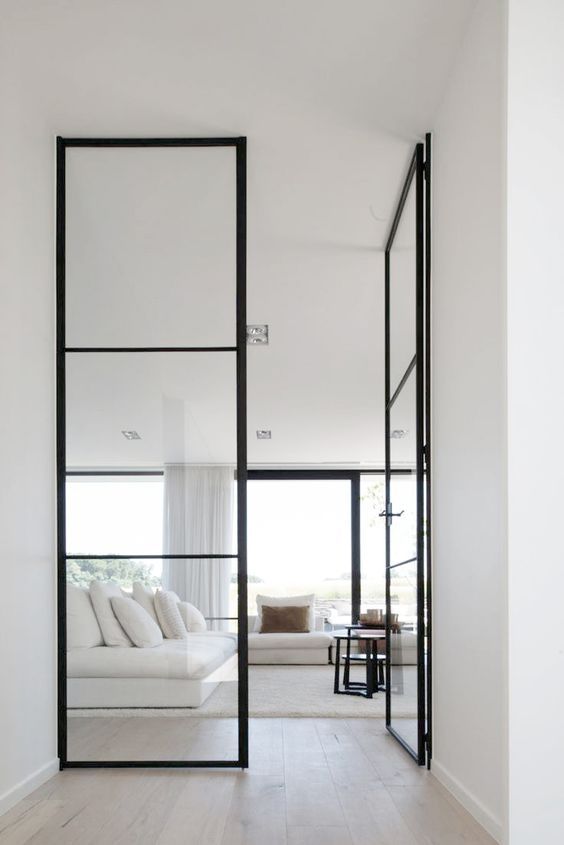 floor to ceiling black framed glass doors look perfect in a neutral modern ambience