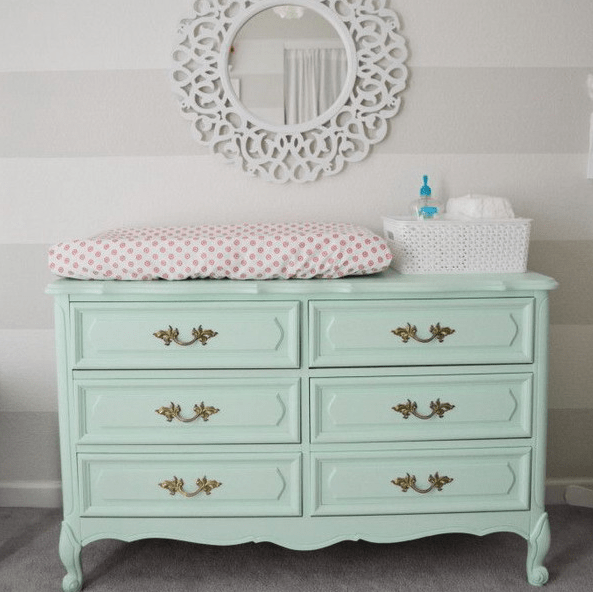Mint colored dresser repurposed into a diaper changing table