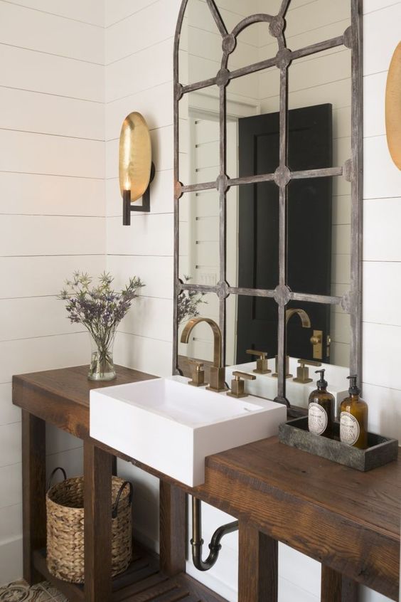 rustic industrial bathroom with a drak stained reclaimed wood vanity and a shelf for storage