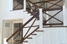 18 rustic stained wood staircase and railing with cables used just for a graphic and more modern look