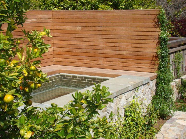 wooden privacy fence surrounding a spa outdoors