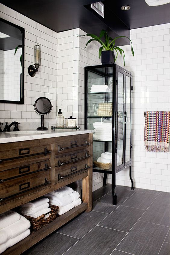 rustic reclaimed wood bathroom vanity with metal handles and an open shelf
