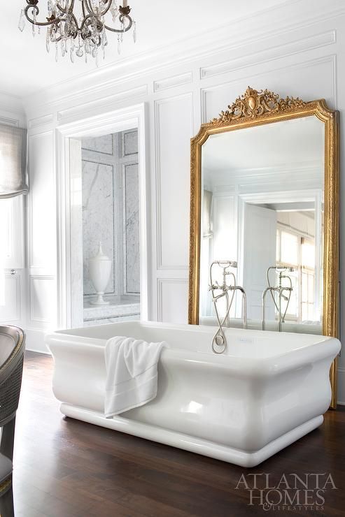 large mirror in a refined gilded frame is a great deoc ridea for a bathroom
