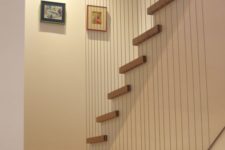 20 vertical cable railing gives a unique look to this staircase and separates it from the rest of the space