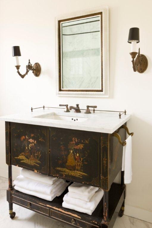 adorable vintage vanity with painted images, an open shelf and a marble counter