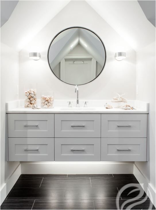 beautiful grey floating vanity that takes the whole niche