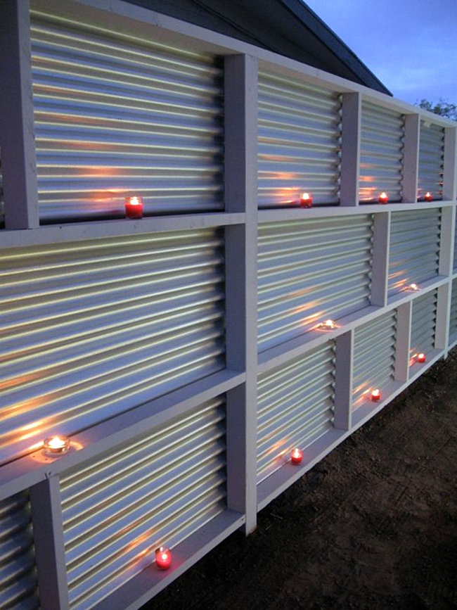 A corrugated metal fence can become realyl cool looking if you place some candles there