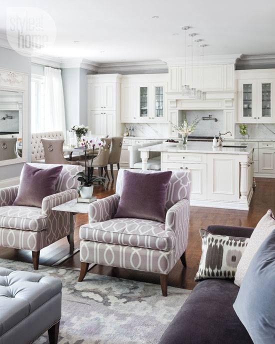 All white kitchen and a purple family room, look so airy and inviting