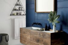 22 dark wood bathroom cabinet with drawers on a contrasting navy wall