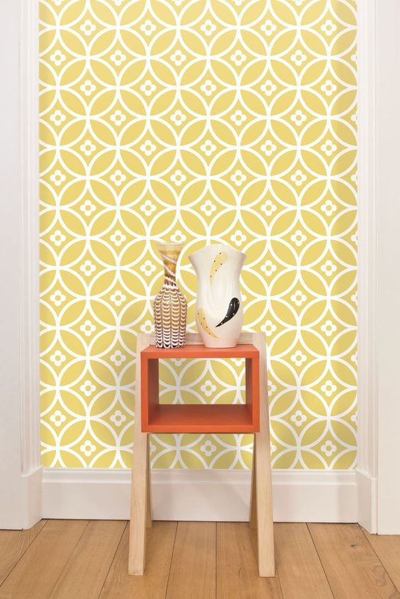 geometric yellow and white wallpaper with tine flowers in an entryway