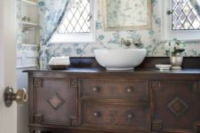 23 dark stained wooden vanity with drawers and an open shelf with baskets