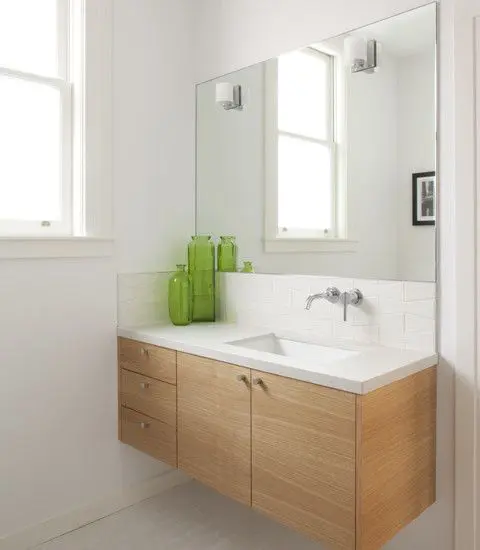 floating light-colored vanity with drawers and a whte top