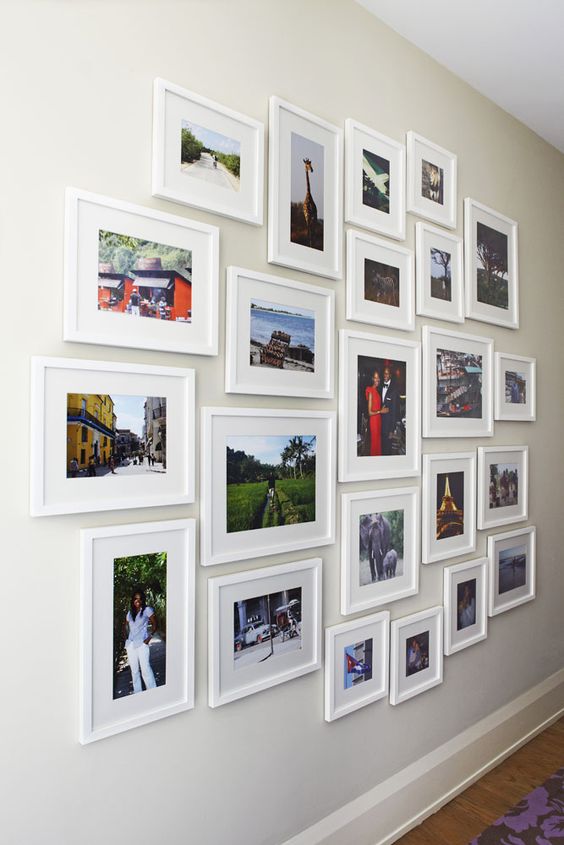 Perfectly arranged gallery wall with pics of different sizes.