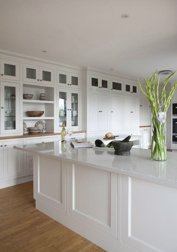 White quartz countertops, cabinets and some green plants for a eco friendly home