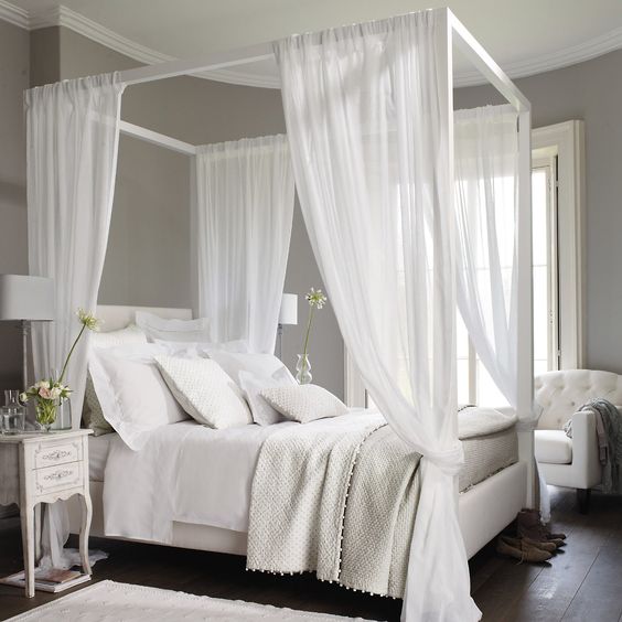 white wood frame bed with white curtains is a great idea to relax and feel peaceful
