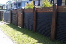 23 wood and corrugated metal create a very eye-catchy and stylish fence