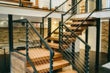 24 ultra-modern yet a bit rustic light-colored reclaimed wood staircase with dark metal and cable railing